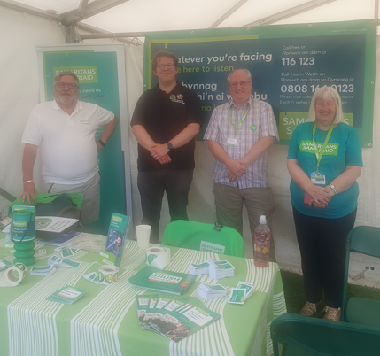 4 people at an exhibition stand